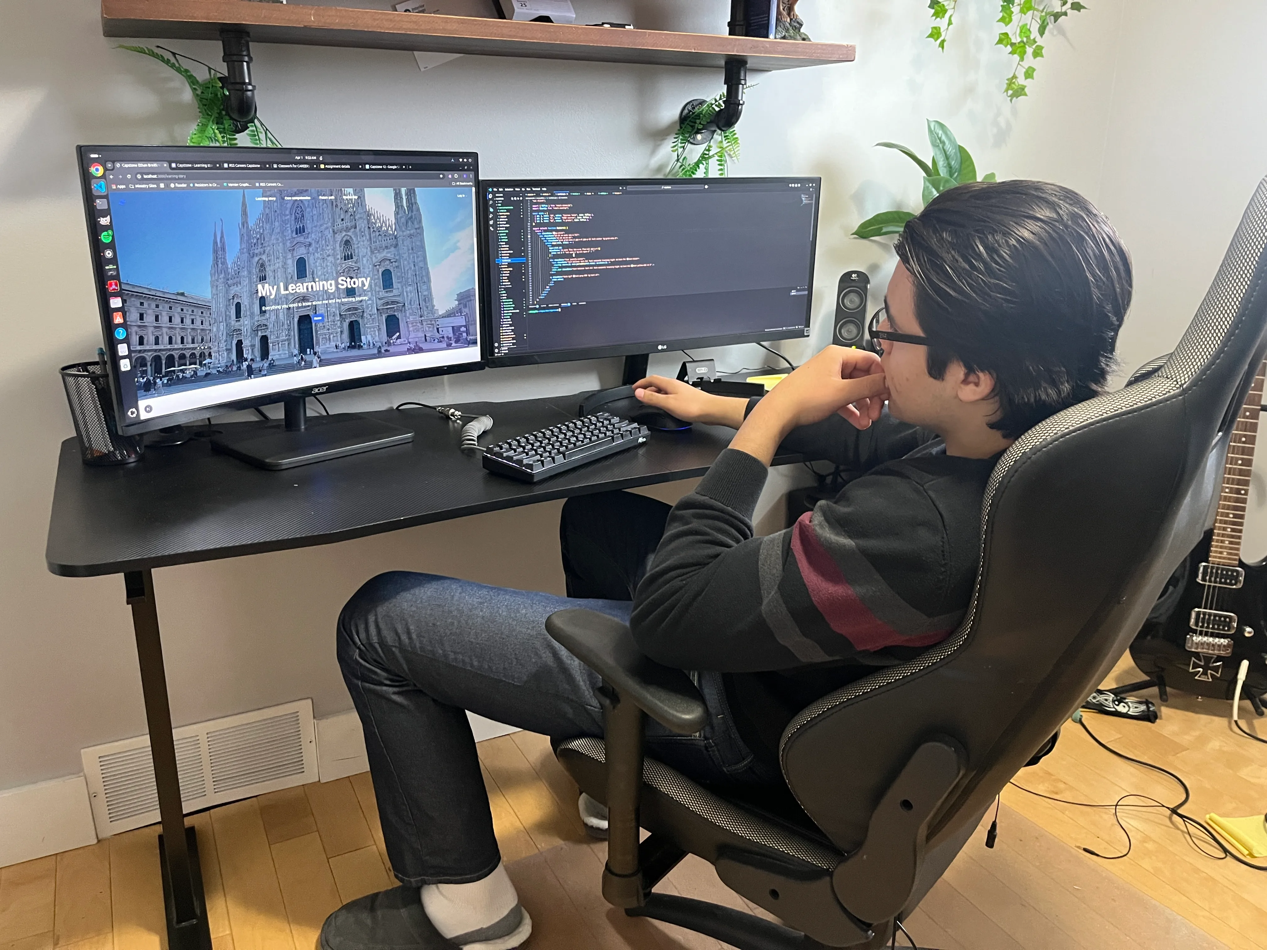 Photo of Ethan Breitkreutz at his desk doing web development